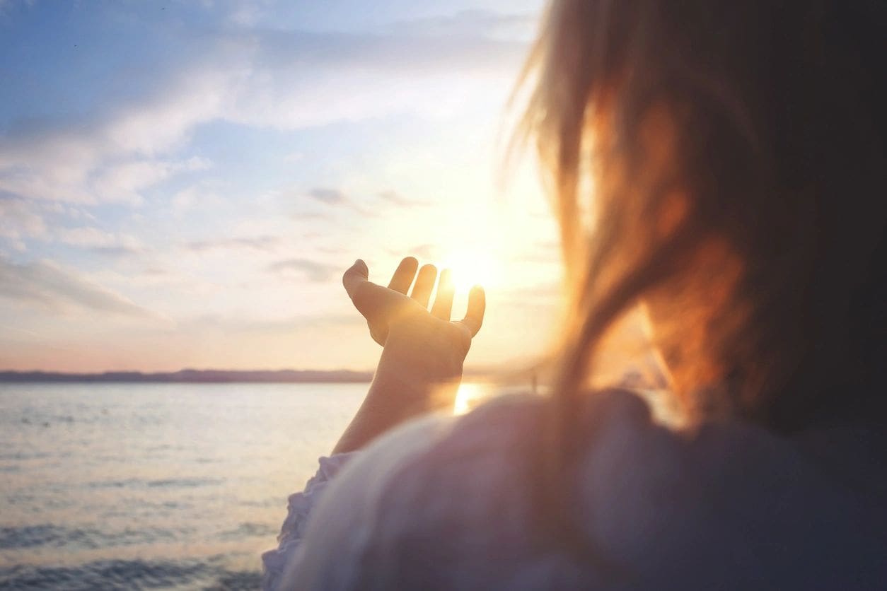 A person is holding their hands up in the air.